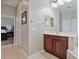 Bathroom featuring a vanity with storage and an adjacent door to the main bedroom at 3840 Caledonia Ave, Apopka, FL 32712