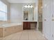 Bright bathroom featuring a soaking tub, shower, vanity, and lots of natural light at 3840 Caledonia Ave, Apopka, FL 32712