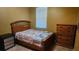 Bedroom with wood furniture, a bright window, and tiled floors offering a peaceful space at 3840 Caledonia Ave, Apopka, FL 32712