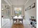 Elegant dining room featuring a wooden table, upholstered chairs, and natural light from a window at 3840 Caledonia Ave, Apopka, FL 32712