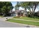 Charming single-Gathering home boasts a manicured lawn, colorful flowerbeds, and a three-car garage at 3840 Caledonia Ave, Apopka, FL 32712