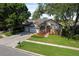 Well-maintained home with lush landscaping, a manicured lawn, and mature trees in a desirable neighborhood at 3840 Caledonia Ave, Apopka, FL 32712