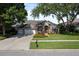 Beautiful home featuring a three-car garage, well-maintained lawn, and elegant landscaping at 3840 Caledonia Ave, Apopka, FL 32712