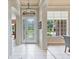 Welcoming foyer with tiled flooring, decorative front door, and bright natural light from adjacent windows at 3840 Caledonia Ave, Apopka, FL 32712