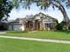 Charming single-story home with stone accents, manicured lawn, and a two-car garage in a well-maintained neighborhood at 3840 Caledonia Ave, Apopka, FL 32712