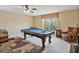 Game room featuring a pool table, ceiling fan, window for light, and cozy seating area at 3840 Caledonia Ave, Apopka, FL 32712