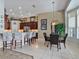 Open kitchen features an island with seating and tile floors that lead to a breakfast nook at 3840 Caledonia Ave, Apopka, FL 32712