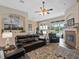 Spacious living room with a fireplace, vaulted ceilings, and views of the pool at 3840 Caledonia Ave, Apopka, FL 32712