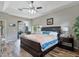 Spacious main bedroom with wood flooring, a tray ceiling, and sliding glass doors to the outdoor area at 3840 Caledonia Ave, Apopka, FL 32712
