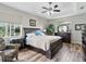 Bright main bedroom featuring a ceiling fan, wood floors, and large windows for lots of natural light at 3840 Caledonia Ave, Apopka, FL 32712