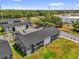 Aerial view of a gray two-story apartment complex showcasing lush greenery and parking at 4160 Pershing Pointe Pl # 4, Orlando, FL 32822