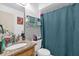 Bathroom showcasing a granite countertop sink, toilet, and shower with a blue patterned curtain at 4160 Pershing Pointe Pl # 4, Orlando, FL 32822