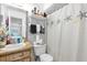 Bathroom with modern fixtures including a wood finish sink and a shower with a starfish themed curtain at 4160 Pershing Pointe Pl # 4, Orlando, FL 32822
