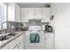 Efficient kitchen with white cabinets, granite counters, and modern appliances at 4160 Pershing Pointe Pl # 4, Orlando, FL 32822