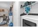 Laundry room with a modern washer and dryer inside of a closet space with shelving for storage at 4160 Pershing Pointe Pl # 4, Orlando, FL 32822