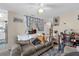 Comfortable living room with a sofa, dining table, and neutral decor, creating a warm ambiance at 4160 Pershing Pointe Pl # 4, Orlando, FL 32822