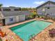 Overhead shot of a fenced in pool with lounge seating and palm trees in the distance, perfect for relaxing at 4160 Pershing Pointe Pl # 4, Orlando, FL 32822