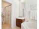Bright bathroom features a glass enclosed shower and a vanity with cherry wood cabinets at 4301 Heirloom Rose Pl, Oviedo, FL 32766