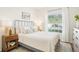 Bright bedroom featuring a soft bed, natural light from the window, and two nightstands at 4301 Heirloom Rose Pl, Oviedo, FL 32766