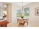 Cozy breakfast nook with scenic pond views, a modern chandelier, and comfortable seating for four at 4301 Heirloom Rose Pl, Oviedo, FL 32766