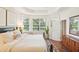 Serene main bedroom with tray ceilings, pond views, and a luxurious ensuite bathroom for relaxation at 4301 Heirloom Rose Pl, Oviedo, FL 32766