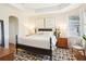 Spacious main bedroom with tray ceilings, stylish furnishings, and hardwood floors for comfort and elegance at 4301 Heirloom Rose Pl, Oviedo, FL 32766