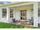 Covered brick patio with chairs overlooking the backyard at 4301 Heirloom Rose Pl, Oviedo, FL 32766