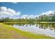 Scenic view of a calm pond reflecting the trees and sky, set in a serene community at 4301 Heirloom Rose Pl, Oviedo, FL 32766