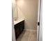 Bathroom featuring a double sink vanity with dark wood cabinets and tile flooring at 4427 Blackbird St, Kissimmee, FL 34746