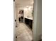 Bathroom with double sink vanity, tile floors, and a walk-in closet at 4427 Blackbird St, Kissimmee, FL 34746