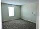 An empty bedroom with neutral walls and carpet, and a window with natural light at 4427 Blackbird St, Kissimmee, FL 34746