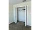 A small open bedroom closet with bi-fold doors and a top shelf at 4427 Blackbird St, Kissimmee, FL 34746