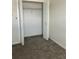 Bedroom closet with bi-fold doors, carpet flooring, and a top shelf at 4427 Blackbird St, Kissimmee, FL 34746