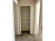 An open hallway closet with three wire shelving racks and carpet flooring at 4427 Blackbird St, Kissimmee, FL 34746