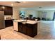 Kitchen view of a large island featuring a double sink and dishwasher with room to eat at 4427 Blackbird St, Kissimmee, FL 34746