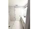 Bathroom boasts a marble-look tiled shower and modern vanity with black hardware at 4919 Nw 61St Ct, Ocala, FL 34482