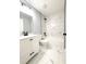 Renovated bathroom features a modern white vanity, white marble styled tile, and black fixtures at 4919 Nw 61St Ct, Ocala, FL 34482