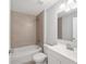 Well-lit bathroom featuring a shower-tub combo with tile surround, a vanity, and modern fixtures at 4919 Nw 61St Ct, Ocala, FL 34482