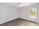 Comfortable bedroom featuring gray flooring and a ceiling fan, creating a modern and inviting space at 4919 Nw 61St Ct, Ocala, FL 34482
