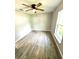 This is a clean and bright bedroom featuring new wood look tile flooring, ceiling fan, and a window at 4919 Nw 61St Ct, Ocala, FL 34482