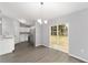 Bright dining area with gray floors, a modern chandelier, and sliding doors to the backyard at 4919 Nw 61St Ct, Ocala, FL 34482