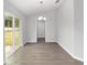 Dining area with sliding glass doors leading to the backyard and modern gray floors at 4919 Nw 61St Ct, Ocala, FL 34482