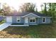 A single-story home with a blue exterior, a one-car garage, and a freshly laid lawn at 4919 Nw 61St Ct, Ocala, FL 34482