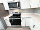 Close-up of the kitchen appliances and cabinets, featuring stainless steel and white finishes at 4919 Nw 61St Ct, Ocala, FL 34482