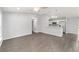 Bright, open living space with modern gray floors and a partial view of the adjacent kitchen at 4919 Nw 61St Ct, Ocala, FL 34482