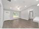Bright living room featuring gray floors, a ceiling fan, and large windows, offering a modern feel at 4919 Nw 61St Ct, Ocala, FL 34482