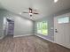 Bright living room features wood-look tile, a ceiling fan, and a view of the bathroom at 4919 Nw 61St Ct, Ocala, FL 34482