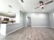 Open-concept living space features wood-look tile and a kitchen bar at 4919 Nw 61St Ct, Ocala, FL 34482