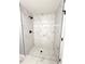 Modern walk-in shower featuring marble-look tile and black shower fixtures at 4919 Nw 61St Ct, Ocala, FL 34482