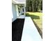 A concrete walkway leads to the front door of a newly constructed home, bordered by fresh mulch and green grass at 4919 Nw 61St Ct, Ocala, FL 34482